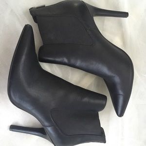 Black Pointed faux leather boots.